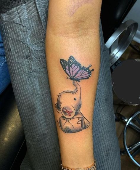 27 Small Elephant Tattoo Ideas: An Inspiring Collection Mom And Daughter Elephant Tattoo, Elephant Tattoos With Butterflies, Tattoo Idea For Mom Who Passed, Elephant With Butterfly Tattoo, Cute Dumbo Tattoo, Elephant Butterfly Tattoo, Elephant Memorial Tattoo, Small Elephant Tattoo Ideas, Small Elephant Tattoo