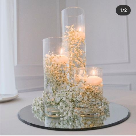 Cylinder Vases With Floating Candles And Greenery, No Flowers Wedding Centerpieces, Baby’s Breath With Floating Candles, Gypsophila And Candles Wedding, Candles And Baby’s Breath Centerpieces, Timeless Wedding Decor Romantic, Simple White Flower Centerpieces, Baby’s Breath Wedding Centre Pieces, Baby’s Breath Centerpiece Diy