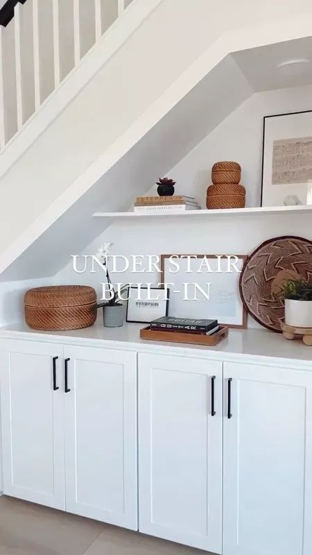 These built-in cabinets with open shelves above really turned out great. It was the perfect solution for the cut-out space that was under my client's stairs! ……………………………………With my online interior design services, I design, you implement, and together we create a cohesive design plan tailored to your style! 🙌🏻 Click the “Get Started” link in bio to learn more about my process. I would love to work with you! ………………………………… #openshelves #builtins #ltkhome #interiordesign #shopltk Niche Under Stairs, Under The Stairs Built Ins, Floating Shelves Under Stairs, Storage Above Stair Box, Storage In Stair Risers, Under Stair Open Storage, Under Stairs Decor, Under Stair Cubby, Shaker Under Stairs Storage