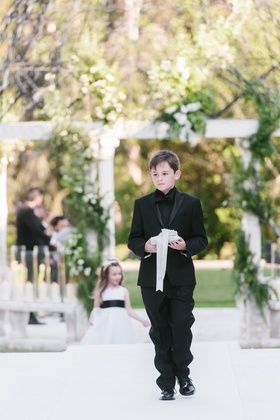 Ring Bearer in Black Tuxedo %26 Black Shirt Photography: Amy %26 Stuart Photography Read More: http://www.insideweddings.com/weddings/cheryl-burke-and-matthew-lawrence/1358/ Black Tuxedo Black Shirt, Ring Bearer Outfit Black, Black Ring Bearer, Matthew Lawrence, Shirt Photography, Cheryl Burke, Photo Ring, Bearer Outfit, Tuxedo Black