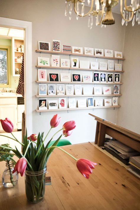 Maybe we can get some ledge shelves (in white?) and put them on the wedding wall to showcase the wedding cards we've gotten. Postcard Display, Photowall Ideas, Photo Ledge, Postcard Wall, Display Family Photos, Photo Mural, Wedding Wall, Design Sponge, Hanging Pictures