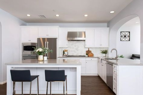 10 Small Kitchen Remodels with Big Design Impact | Sea Pointe Cabinets With Gray Countertops, Textured Tile Backsplash, Sleek Kitchen Design, Light Grey Kitchen Cabinets, Island Seating, Light Wood Kitchens, Light Grey Kitchens, White Kitchen Backsplash, White Tile Backsplash