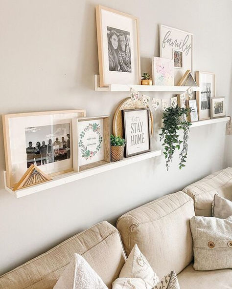 23 Stunning Ledge Ideas That Will Transform Your Living Room Pictures On Wall Shelf, How To Decorate Shelves With Pictures, Photo Frame Shelf Display, Back Of The Couch Wall Decor, What To Hang On Walls In Living Room, 3 Staggered Floating Shelves, Two Shelves On Wall Living Room, Family Picture Living Room Wall, Picture Wall Ledge Ideas