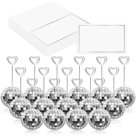 PRICES MAY VARY. Package Includes - You will receive 20pcs of disco ball card holders, 20pcs of heart swirl wires and 20pcs of tented cards, complete and value set to meet your various needs. Dazzling Silver Look - Bling silver disco ball bases with heart swirl wire, and place cards with silver foil frame, our place cards and holders set are delicate and glamourous, which can light your guests eyes up and leave them deep impressions. Good Quality - The disco ball stands that made of foam and dec Disco Ball Table, Wedding December, Disco Birthday, Disco Birthday Party, Couples Bridal Shower, Table Number Holders, Disco Theme, Ball Wedding, Wedding Display