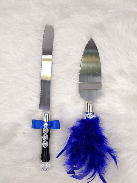 PRICES MAY VARY. Knife handle is designed like a groom in black suit, wearing a royal blue satin bow tie, rhinestones as button on black shirt, very detail and delicate. The cake server handle is also decorated in royal blue feather dress like a bride, with rhinestone necklace decoration. Made of stainless steel, safe and sound. Please check size detail at description part. Can be a lovely gift and a great keepsake item for new couple, and anniversary gift as well. Toasting glass set in same des Blue And Black Wedding Decor, Feather Dress Black, Blue Feather Dress, Steel Blue Weddings, Wedding Cake Knife And Server, Cobalt Blue Weddings, Black Feather Dress, Black Wedding Decorations, Black Suit Dress