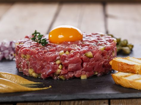 According to the legend, the name "Steak or Beef Tartare" refers to the Tartars, the nomads who roamed Eastern Europe, for a time under the leadership of Attila the Hun. Fierce and bloodthirsty, the Tartars purportedly ate raw meat for strength. Tartare Recipe, French Appetizers, Steak Tartare, Perfect Steak, Czech Recipes, French Food, Eating Raw, Beef Dishes, Meat Recipes