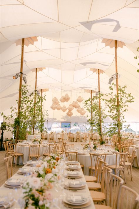 This stunning wedding reception features a beautifully designed tent with natural wood accents, lush greenery, and elegant floral arrangements. The open and airy setup is enhanced by unique light fixtures and a soft, neutral color palette, creating a warm and inviting atmosphere. #WeddingReception #TentWedding #NaturalDecor #ElegantWedding #WeddingInspiration #LuxuryWedding #OutdoorWedding #FloralArrangements #GardenWedding Outdoor Tent Wedding Reception, Wedding Tent Layout, Lake Wedding Reception, Elegant Tent Wedding, Wedding Tent Lighting, Wedding Tent Decor, Soft Neutral Color Palette, Wild Flower Arrangements, Traditional White Wedding