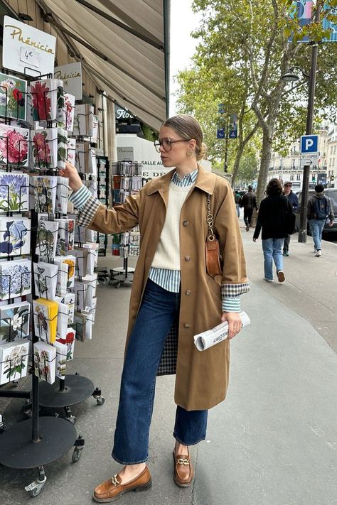 @elodieromy is wearing the Sézane Clyde Trench, paired with Vicky loafers, the Max striped shirt, and a cozy white knit sweater. This effortlessly chic outfit is perfect for transitional fall weather. Shop this outfit online now at sezane.com. Striped Shirt Outfit Fall, London Outfit Ideas, Striped Sweater Outfit, Outfits With Striped Shirts, Simple Wardrobe, Fall Layering, London Outfit, Effortlessly Chic Outfits, White Knit Sweater