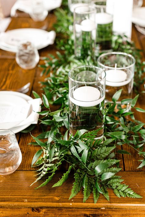 Wedding reception table runner, Italian ruscus, greenery, leatherleaf, floating candles, farmhouse table, classic wedding, whimsical wedding, white wedding, Spring wedding, Pear Tree Estate, Champaign wedding, Illinois wedding, central Illinois wedding, midwest wedding, J.Blu Wedding Florist, Peoria wedding, NRS Photography, table runner, wedding table runner, candle table runner, wedding reception, reception decor, greenery table runner, floating candles, wedding centerpiece, wedding flowers Fern Centerpiece Wedding, Reception Table Runner, Italian Ruscus Greenery, Spray Roses Boutonniere, White Spring Wedding, Ruscus Greenery, Greenery Wedding Table, Greenery Runner, Bride Groom Table