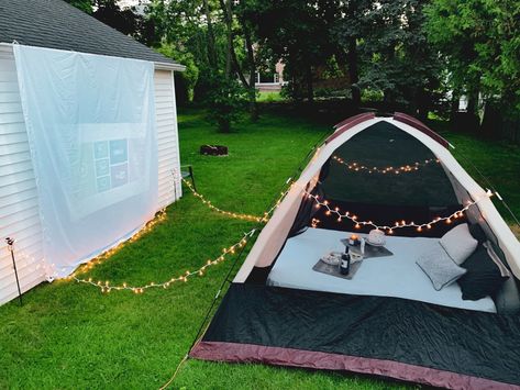 Set up a tent, white sheet, pillows + blankets, lights, and buy an inexpensive projector for an outdoor movie night! Tent Projector Movie Night, Backyard Movie Date Night Ideas, Outdoor Movie Date Night, Tent Movie Night, Projector Date Night Outside, Outdoor Movie Night Cold, Garden Projector Movie Nights, Camping Movie Night Projectors, Backyard Movie Screen