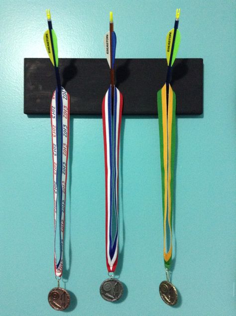 Archery medal board Archery Decorations Ideas, Archery Medal Display, Archery Decor, Archery Room, Archery Storage, Archery Trophy, Archery Crafts, Archery Medal, Medal Board