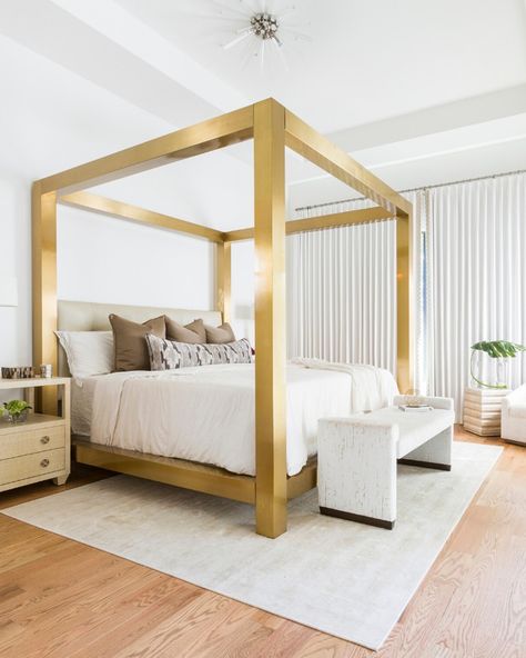 Rescuing us from those quarantine blues is this striking canopy bed from @bernhardtfurniture. Nestled between white walls and neutral elements, this gold bed frame illuminates both the room and our spirits! Visit the #linkinbio to see more of this serene and relaxed home. Bernhardt Bed, Gold Bed Frame, Romantic Bedroom Design, Beautiful Bed Designs, Gold Bedroom Decor, Canopy Bed Frame, Gold Rooms, Gold Bed, Bed Design Modern