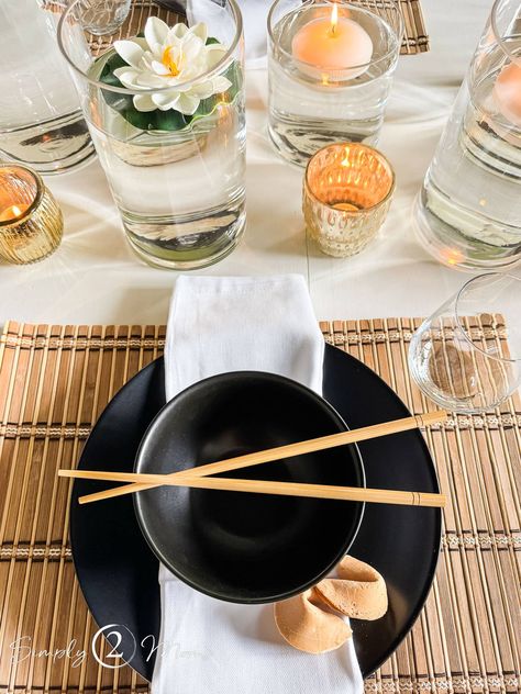 Want to elevate your Asian dinner party? Discover a modern approach to Chinese table styling that's both chic & elegant. Forget the red lanterns and dragons! Let's ditch those cliches and set a beautiful tablescape with a few classic touches. Whether your entertaining for the lunar new year or grabbing takeout let's make this a Chinese dinner party that your guests will be talking about. Red And Black Table Decorations, Chinese Dinner Party, Asian Dinner Party, Chinese Table Setting, Sushi Dinner Party, Asian Dinner, Chinese Dinner, Dinner Party Table Settings, Asian Party