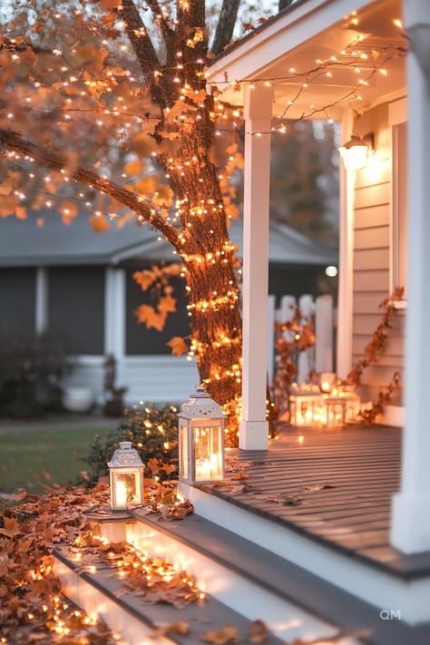 Outdoor fall terrace decor with string lights and lanterns creating a cozy atmosphere on a front porch, adorned with autumn leaves. Autumn Exterior Decor, Fall Decor Exterior, Thanksgiving Porch, Mums In Pumpkins, Pinterest Pictures, Sunshine Homes, Festive Centerpieces, Fall Designs, Fall Decor Inspiration