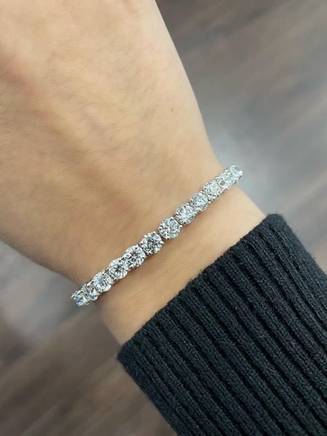 The 12.52 ct Platinum Round Diamond Tennis Bracelet is a truly breathtaking piece of jewelry that showcases the beauty and brilliance of high-quality diamonds. This bracelet features a stunning row of 12.52 carats of round diamonds that have been expertly set in a classic tennis bracelet design. The diamonds are carefully selected for their exceptional quality, ensuring that they have a perfect balance of color, clarity, and cut. The round diamonds in this bracelet are of exceptional quality, with a clarity rating of SI1-SI2 and a color rating of F-G. This means that they are of very high quality and are virtually free from any visible flaws or blemishes. The diamonds have been cut to maximize their brilliance and sparkle, making them a truly dazzling sight to behold. The bracelet is 7 inc Round Diamond Tennis Bracelet, Tenis Bracelet, Royalty Accessories, Wrist Weights, Diamond Tennis Bracelet, Bracelet Design, Classy Jewelry, Tennis Bracelet Diamond, Jewelry Inspo