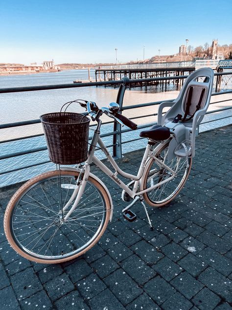 A Pendleton bike with a wicker basket on the front and a child seat attached to the back, parked in front of river and pier. Pendleton Bike, Kids Seating, Pretty Pictures, Bicycle, Bike