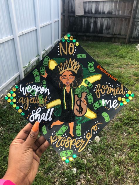 No weapon formed against me shall prosper Jamaica grad cap black queen money natural hair gold crown grad cap Instagram : @mickeyyant Mickeyyant.com Jamaica Graduation Cap, Jamaican Graduation Cap Ideas, Crown Grad Cap, Funny Graduation Cap Decoration, Cap Instagram, Diy Grad Cap, Grad Cap Ideas, Funny Graduation Caps, Creative Graduation Caps