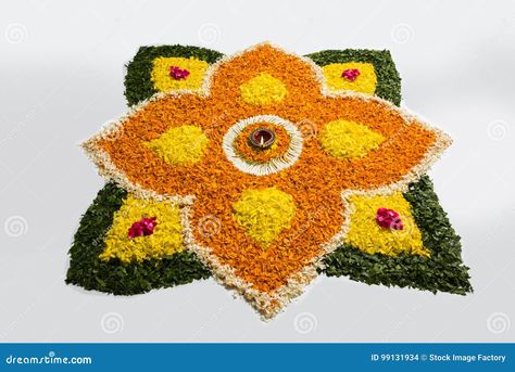 Flower rangoli for Diwali or pongal or onam made using marigold or zendu flowers and red rose petals over white background with diwali diya in the middle, selective focus Marigold Flower Rangoli, Flower Rangoli For Diwali, Pretty Flower Names, Rangoli Images, Flower Rangoli Designs, Rangoli For Diwali, Simple Flower Rangoli, Rangoli Ideas, Red Rose Petals