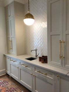 Butlers Pantry White Cabinets, Herringbone Kitchen Tile Backsplash, Tile And Cabinet Combinations, Kitchen Tiles To Ceiling, Wet Bar Butlers Pantry, Oversized Mirror Over Buffet, Neutral Herringbone Backsplash, Tan Herringbone Backsplash, Butlers Pantry With Bar