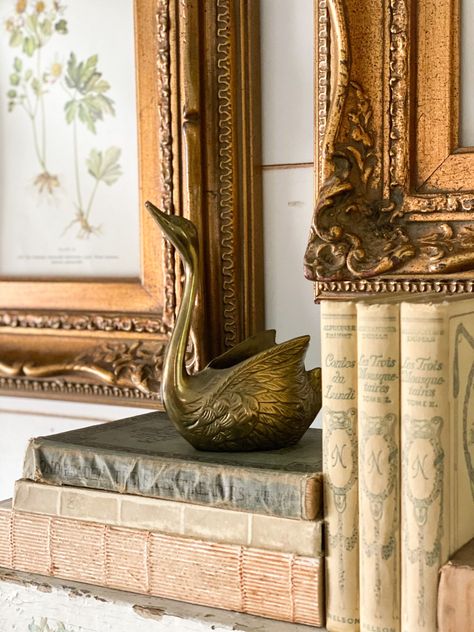 Looking for ways to refresh your mantel with a vintage look? Check out my tips to decorate a mantel using some of my favorite vintage finds! #robynsfrenchnest #springdecor #antiques #frenchfarmhousedecor Vintage Brass Decor, Brass Swan, Vintage Vignettes, French Farmhouse Decor, Church Pew, Paint Colors For Living Room, Brass Decor, Affordable Home Decor, Antique Design