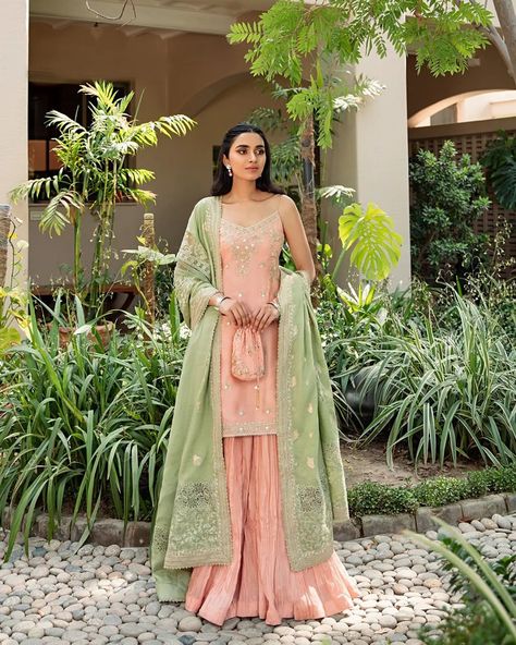 Click to view the outfit details. The fitted kurti of Mahi gorgeously pairs with a voluminous crushed sharara and a contrasting mint green dupatta. Delicate threadwork along with sheesha and sequins add the perfect bling to this sophisticated look. #FaizaSaqlain #Saanjh #Luxuryfestive #Newcollection Fitted Kurti, Crushed Sharara, Green Kurti, Faiza Saqlain, Green Sharara, Wedding Lenghas, Ethenic Wear, Green Dupatta, Eid Outfit