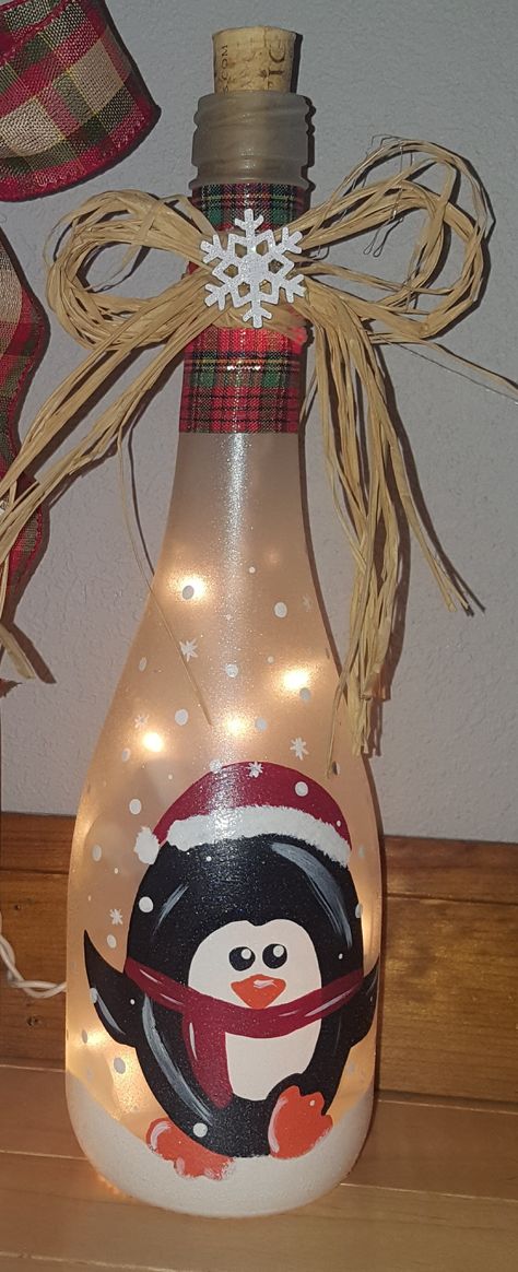 Painted lighted penguin wine bottle Paint Wine Bottles Christmas, Wine Bottle Art Christmas, Elf Wine Bottle, Christmas Painted Wine Bottles, Painted Wine Bottles With Lights, Painted Wine Bottles Christmas, Wine Bottle Painting Ideas, Christmas Wine Bottle Crafts Diy, Reindeer Wine Bottle