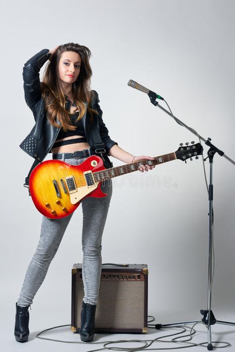 Young woman with guitar in her hand stock image Holding Gutair Pose Drawing, Rock Poses Drawing, Person Holding Guitar, Guitarist Pose, Pose With Guitar, Poses With Guitar, Woman Guitarist, Art Reference Poses Models, Guitar Pose Reference