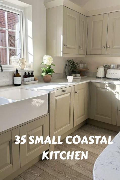 Beige coastal kitchen with window, farmhouse sink, and potted plant on counter. Text: "35 Small Coastal Kitchen". Beach House Galley Kitchen, Small Beach House Kitchen Coastal, Coastal Kitchen Ideas Seaside, Small Beach House Kitchen, Small Coastal Kitchen Ideas, Coastal Kitchen Cabinets, Small Coastal Kitchen, Coastal Cottage Kitchen, Kitchenette Design