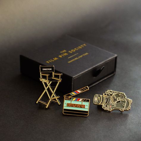 The Director's Box Set is perfect for well...any kind of director! Pin Details: Director's Chair: 2" Black nickel metal with two locking backs Cinema Camera: 1.75" Gold metal with two locking backs Timecode Slate: 1.4" Gold metal with two locking backs. *GLOWS IN THE DARK* Orders shipped outside the U.S. are subject to import taxes (VAT) payable by the customer at time of delivery. Film Pin Society is not not responsible for these duties. Director Gifts, Cinema Gift, Cinema Box, Director's Chair, Pin Box, Movies Box, Directors Chair, Cinema Camera, Nickel Metal