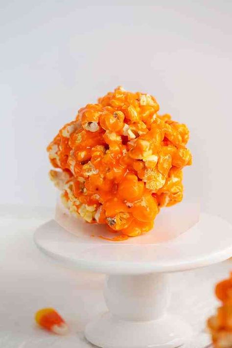 Halloween Popcorn Balls - These Candy Corn Popcorn Balls are a vibrant orange color and coated with a creamy candy corn glaze. They're sticky but aren't chewy like traditional popcorn balls. They make a great treat to make for your kids this Halloween. #halloween #cookiedoughandovenmitt #popcornballs #candycorn #dessertrecipes Candy Corn Popcorn Recipes, Candy Corn Popcorn Balls, Halloween Popcorn Balls Recipe, Watermelon Sorbet Recipe, Butterfinger Bites, Candy Corn Popcorn, Halloween Popcorn Balls, Popcorn Balls Recipe, Watermelon Sorbet