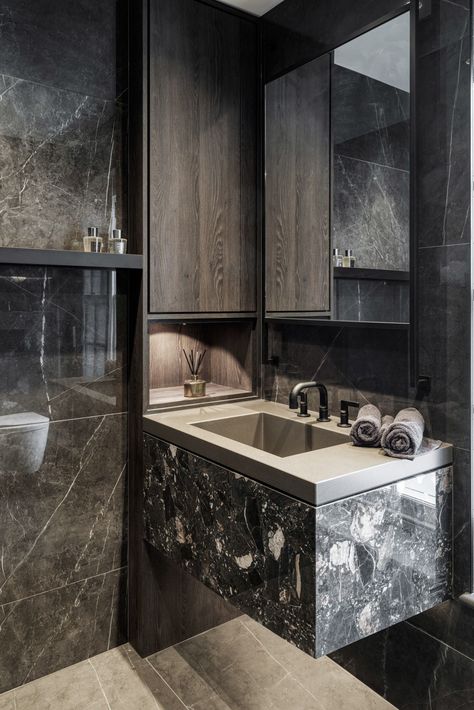 This moody masculine bathroom was created as the second ensuite as part of the master bedroom layout the other ensuite being light and feminine. 
We used a dark polished large format porcelain tile in Malabite Allegra from @solusceramics. 
A matt grained dark timber worked well with the polished tile for the bespoke joinery pieces 
The beautiful @gessi_official dark bronze taps and brassware finish the scheme. 
Click to see more inspiring architectural and interior design ideas to inspire you Bronze Tile Bathroom, Large Format Porcelain Tile, Feminine Bathroom, Bathroom Dark, Bronze Tiles, Masculine Bathroom, Bespoke Joinery, Joinery Design, Bedroom Layout