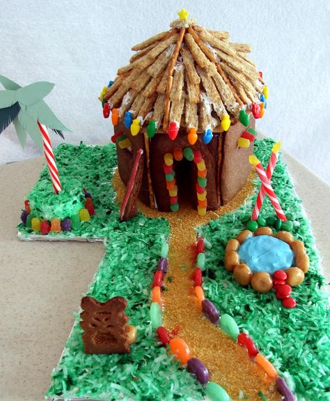 GINGERBREAD TIKI HUT - My Gingerbread Tropical Hut/House.  I used; Roof: triscuit, pretzel sticks, Walkway: corn flakes crumbs, Grass: coconut, Edging: lifesavers, Palm Tree: candy cane, Pool: Ritz crackers, Rocks: Werther's original hard caramel candy, Steps: M&M candy, Tiki Torches: Birthday candles topped with sugared yellow gumdrop, Tiki: Gingerbread cookie, Surfboard: Gingerbread cookie frosted, Hut: Gingerbread cookie decorated with gumdrops, and Wilton candy decorations. #GingerbreadHouse Mele Kalikimaka Party, Graham Cracker Gingerbread House, Homemade Gingerbread House, Cool Gingerbread Houses, Gingerbread Cookies Decorated, Gingerbread House Designs, Hawaiian Christmas, Hawaii Tropical, Gingerbread House Decorations