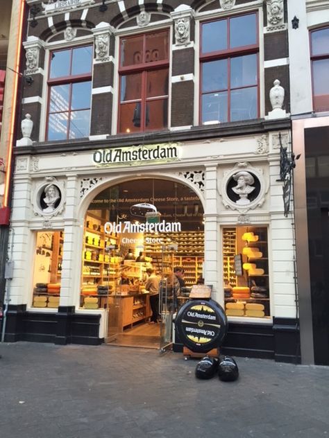 The History of Cheese began in 1946 in Old Amsterdam. The more popular cheese is created by a man named Henry Willigers, and his shops are distributed throughout the city. Old Amsterdam Cheese, as seen in this photo, is the most exported cheese of Holland with over 70% of countries around the world receiving exported cheese from their store. The country boasts having won gold medals for their superior cheese quality, and this store in particular has won competitions around the country. Amsterdam Shopping Street, Ac Villager, Amsterdam Cheese, Amsterdam Iconic Places, Old Amsterdam Cheese, Oranjezicht City Farm Market, Amsterdam City Centre, Cheese Shop, Animal Crossing Characters