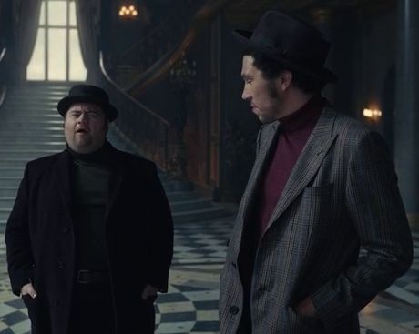 Screenshot from the 2021 film Cruella of two men standing in a lavish mansion. The man in the foreground is wearing a grey jacket with a maroon polo neck sweater and a black hat. He is slim with pale brown skin, black hair, and facial stubble. The man in the background is wearing a black coat with a dark grey polo neck, a black and silver belt, and a black hat that obscures his hair. He is fat with white skin and black facial hair. Jasper And Horace, Cruella 2021, Cruella Costume, Cruella Deville, Funny Drawings, Action Movies, Little Princess, Disney Movies, Sci Fi