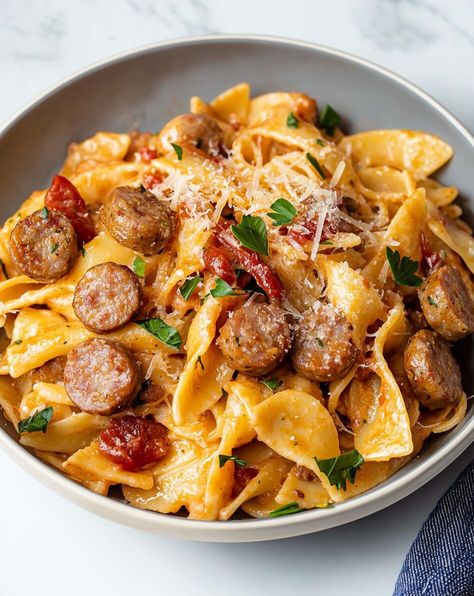 This One-Pot Spicy Sausage Pasta is a comforting meal that brings together the heat of Italian sausage with a rich, creamy sauce. The bowtie pasta perfectly cradles the sauce, making every bite packed with flavor. Garnished with grated Parmesan and fresh parsley, it’s an easy, crowd-pleasing dish that’s ready in […] Creamy Bowtie Pasta, Pasta Roni, Kielbasa Pasta, Spicy Sausage Pasta, Bowtie Pasta, Spicy Sausage, Sausage Pasta, Angel Hair, Kielbasa