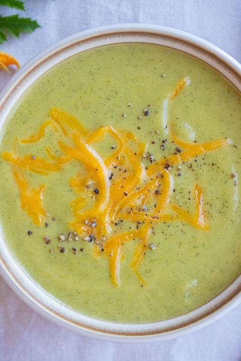 This Cheesy Zucchini Soup is the perfect way to use up your extra zucchinis! It's easy to make, super cozy and it is packed with vegetables and protein. Make a double batch and freeze the rest for later. This veggie packed soup is great for lunch or dinner and can be enjoyed with crackers or crusty bread. #zucchinirecipe #soup #vegetarian #glutenfree #comfortfood Creamy Zucchini Soup, Zucchini Soup Recipes, Soup Vegetarian, Zucchini Soup, Vegetarian Meal Plan, Vegan Cheddar, Cheesy Zucchini, Corn Soup, Main Dish Salads