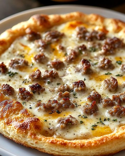 🍴 Biscuits and Sausage Gravy Breakfast Pizza 🍴 "Start Your Day with a Slice of Comfort!" 🍽️ Ingredients 🍽️ - 1 cup sausage gravy, store-bought or homemade - 1/2 cup milk - 1 lb breakfast sausage, crumbled - 1/2 cup diced onion - 1/4 cup all-purpose flour - Salt and pepper, to taste - 2 cloves garlic, minced - 1 tube (16.3 oz) refrigerated biscuit dough - 1/2 cup shredded mozzarella cheese - 1 cup shredded cheddar cheese - 2 large eggs - Fresh parsley, chopped for garnish #BreakfastPizza #S... Sausage Recipes Breakfast, Sausage Gravy Breakfast Pizza, Sausage Gravy Breakfast, Gravy Breakfast, Biscuits And Sausage Gravy, Biscuits And Sausage, Cooking Easy Recipes, Desserts Healthy, Cooking Easy