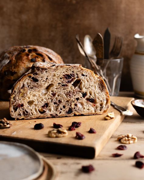 Indulge in the irresistible flavors of our Cranberry Walnut Sourdough Bread, the perfect fusion of tart cranberries and earthy walnuts. Get this sourdough bread recipe on makeitdough.com. Sourdough Bread Food Photography, Cranberry Walnut Sourdough Bread, Flavoured Sourdough Bread, Cherry Sourdough Bread, Cherry Sourdough, Cranberry Walnut Sourdough, Walnut Sourdough Bread, Cranberry Walnut Bread, Sourdough Biscuits