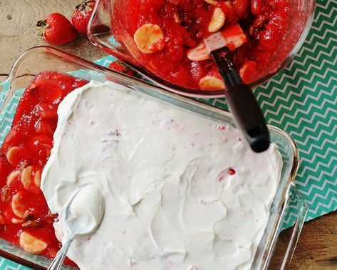 An aerial view of adding the sour cream layer to the strawberry jello salad. Jello Salad With Sour Cream, Strawberry Jello Sour Cream Dessert, Strawberry Sour Cream Jello Salad, Strawberry Congealed Salad Sour Cream, Strawberry Congealed Salad Recipes, Strawberry Jello Salad With Sour Cream, Jello Salad Recipes, Sour Cream Desserts, Pretzel Jello