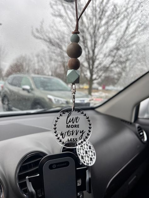 So excited to introduce our new car mirror hangers! This hanger consists of sage, tan, and a wood stained bead. This hanger adds a gorgeous and unique touch to your dash! Each painted bead is sealed! These hangers will add a beautiful touch to your car. Get ENCOURAGED by this quote! This hanger serves as a daily reminder! You can see anytime you drive anywhere! These make for a perfect gift for any family or friends. These car hangers are super easy to add to your mirror. Just tie a knot in the cord at whatever length you want it to be and cut the excess cord! SHIPPING *free shipping  *If you're local, message @emwisecreations to order CLEANING- if the acrylic round needs cleaned just simply take a damp washcloth with a tiny bit of soap and wipe! Dry it off and it'll be good as new! Cricut Keychains, Cricket Joy Projects Craft Ideas, Live More Worry Less, Car Mirror Hanger, Beaded Car Charms, Car Mirror Decorations, Car Mirror Hangers, Car Hanging Accessories, Cricut Explore Air Projects