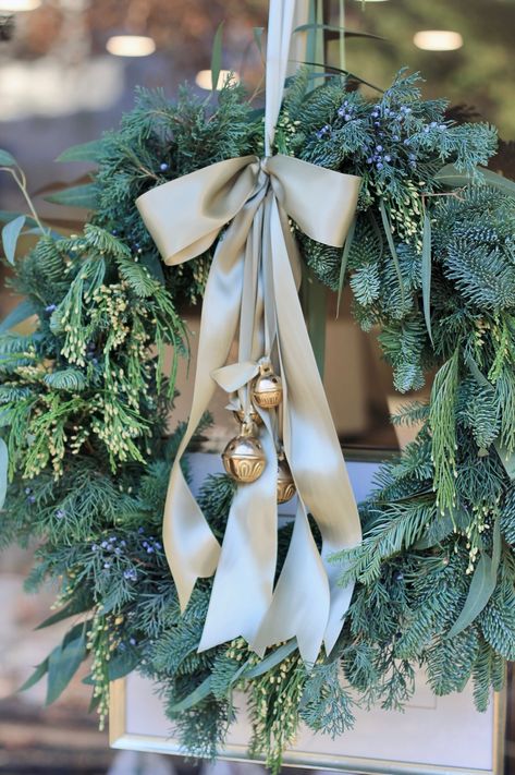 12" Heavy Duty Wire Form with Brackets Snips Floral Wire Steps : Traditional (on store front door) : Create 10 small bundles of greens. I used Noble Fir, Willow Eucalyptus, Incense Cedar & Juniper. I put one sprig of each in the bundle then wrapped the stems together with floral wire. Layer the bundles around the form, overlapping at the stems all the way around. On the last one, you will have to tuck the stems under the first bundle. Bend in wire form to hold bundles to the frame. Wrap the enti White House With Christmas Wreaths On Windows Outside, Woodsy Christmas Wreath, Christmas Decor With Eucalyptus, Wreath With Bells And Ribbon, Wreath For Front Door Christmas, Christmas Wreath Vintage, Vintage Wreaths Christmas, Live Wreaths Christmas, Simple Xmas Decor