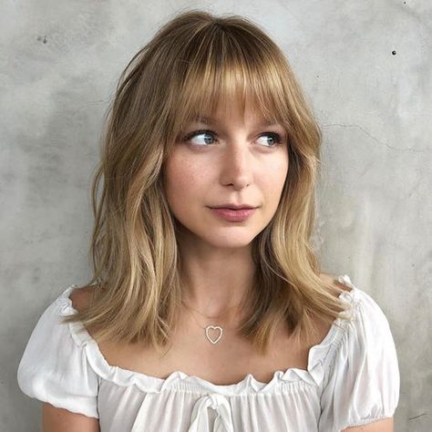 We're firm believers that every woman should try bangs once in her life. For oval faces, bangs are extra flattering. #southernliving #hairstyles #ovalface Cute Modern Haircuts, Wispy Textured Bangs, Thick Bangs Round Face, Medium Hair With Bangs And Glasses, Medium Length Bangs Fringes, Long Bob Bangs Round Face, Short Hair With Fringe Bangs Round Faces, Eyebrow Length Bangs, Short Haircuts For Women With Bangs