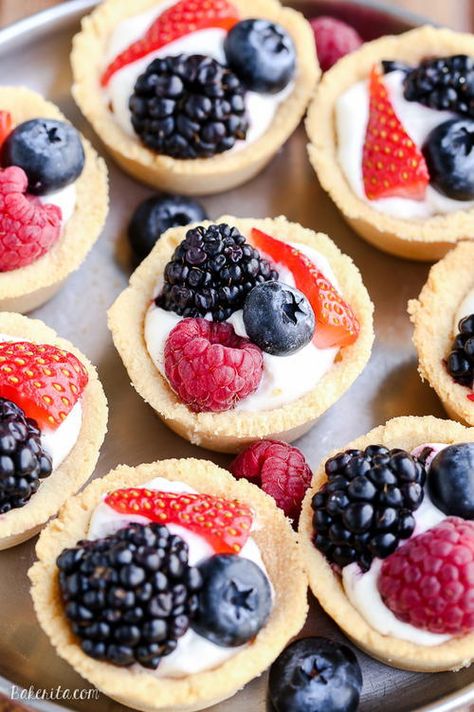 Mini Berry Tarts | If these mini dessert bites don't scream summer, we don't know what does! Coconut Cream Filling, Berry Tarts, Fruit Tarts, Berry Tart, Dessert Bites, Paleo Sweets, Shortbread Crust, Cream Filling, Summer Dessert Recipes