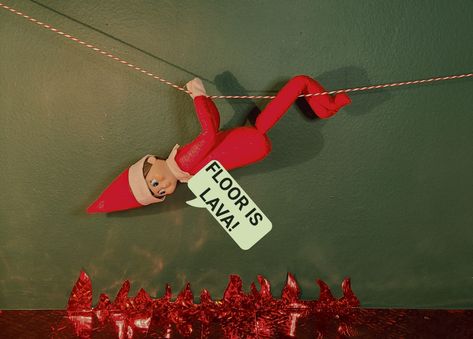 Elf on the shelf rappels across a zip line to avoid the lava below. Lava is made from holographic red wrapping paper. Elf On Shelf Floor Is Lava, Elf The Floor Is Lava, Elf On The Shelf The Floor Is Lava, Zip Line Elf On Shelf, Elf Floor Is Lava, The Floor Is Lava Elf On The Shelf, Elf On The Shelf Floor Is Lava, Floor Is Lava Elf On Shelf, Red Wrapping Paper