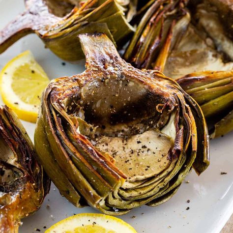 Roasted artichokes are a stunning appetizer! This technique develops deep caramelized flavors in the artichoke heart and the meaty leaves. Easy Stunning Appetizers, Roasted Artichokes Oven, Artichokes Appetizer, Artichoke Roasted, Appetizer Vegetarian, Roasted Artichokes, Artichoke Recipe, How To Cook Artichoke, Baked Artichoke