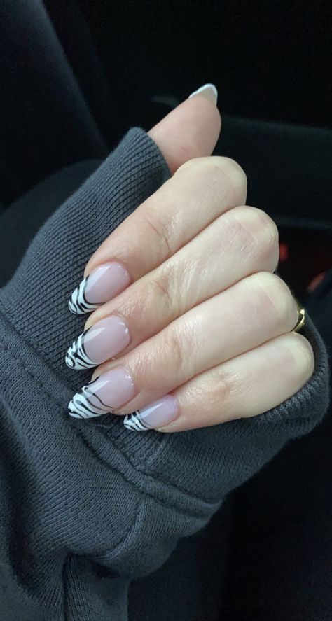 Classic almond shaped french tip on acrylic nails with Zebra nail art🦓 Zebra French Tip Nails Almond, Simple Zebra Tattoo, Zebra Tip Nails, Zebra Nails Acrylic, French Tip Zebra Nails, New Years Nails Almond, Almond French Tip Nails With Design, Zebra French Nails, Zebra Almond Nails