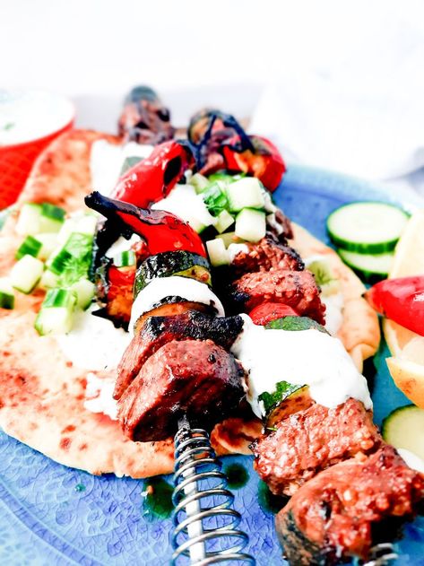 Tender, marinated Greek Inspired Steak Kabobs with Tzatziki, zucchini, mushroom, chili peppers and cucumber dill relish top pita bread. #beefkabobs Cucumber Dill Relish, Mushroom Chili, Dill Relish, Naan Flatbread, Basting Sauce, Cubed Steak, Creamed Cucumbers, Steak Kabobs, Beef Kabobs