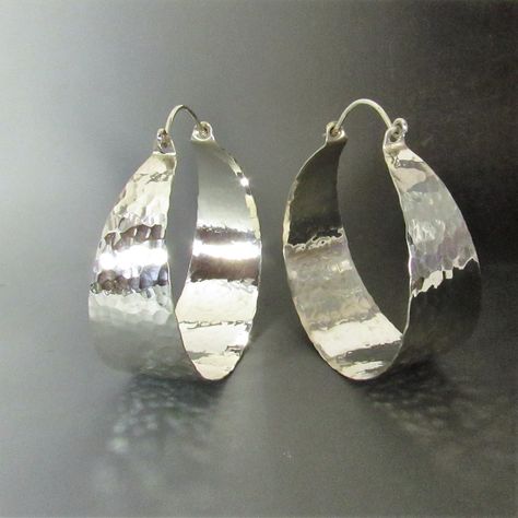 Dazzling they are with their mirror shiny hammered finish, extra large hammered argentium sterling silver hoop earrings. With apx. 1300 hammer strikes to give this pair its wonderful finish and painstakingly polished to a brilliance this is the pair that you wear when you definitely want to be noticed. Although we've never used the word bling to describe our jewelry and we won't start today we will just say this is the pair you wear when you need some serious ZING! Argentium sterling is a tiny b Chunky Silver Jewellery, Silver Statement Jewelry, Hoops Silver, African Earrings, Earrings Big, Funky Jewelry, Jewelry Lookbook, Sterling Silver Hoop Earrings, Large Earrings