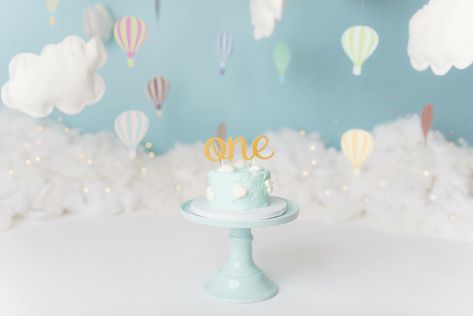 Hot Air Balloon with Clouds Cake Smash Hot Air Balloon Smash Cake One Year Old, Hot Air Balloon Cake Smash Photography, Cloud Smash Cake, Hot Air Balloon Smash Cake, Hot Air Balloon Cake Smash, Clouds Cake, Twin Cake Smash, Balloon Birthday Themes, Cake Smash Inspiration