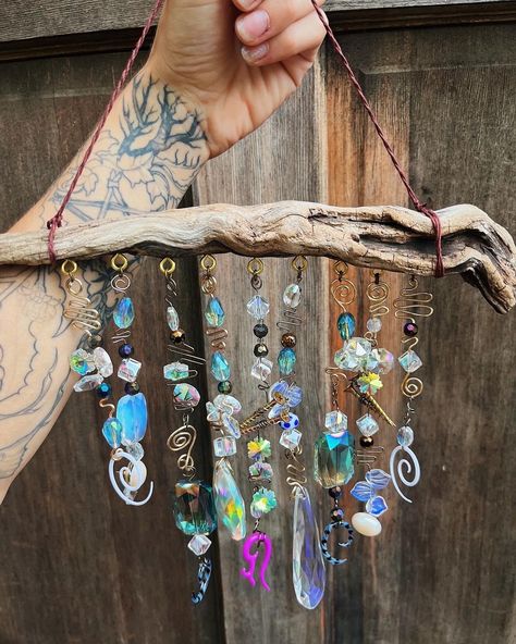 A whimsical, witchy, and dark cottagecore inspired piece of home decor. This one of a kind suncatcher also functions as a wind chime, as the beads, wire and screws hit together.  The suncatcher features crystal rainbow beads, and found objects including repurposed spiral gauges, recycled screws, and other assorted glass beads. The clear crystal beads make beautiful rainbows when the sunlight shines through them. The driftwood suncatcher / wind chime can be hung indoors or outdoors from a wall or Diy Natural Wind Chimes, Crystal Bead Suncatchers, Crystal Door Hanging, Sun Catcher Wind Chimes, Bead Decorations Home Decor, Beaded Window Suncatcher, Sun Catcher Rainbow, Crystal Windowsill, Driftwood Mobile Wind Chimes